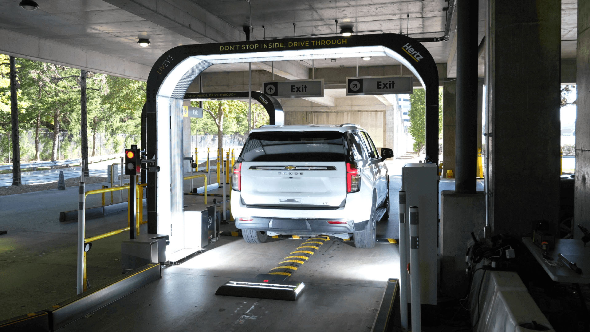 A Hertz rental vehicle drives through one of UVeye's scanners.